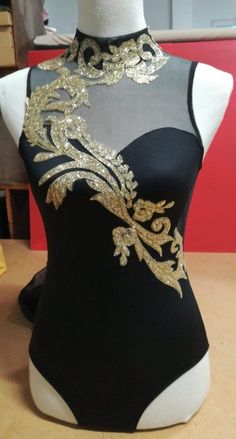 a mannequin with gold and black designs on it