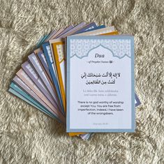 a pile of cards with arabic writing on them