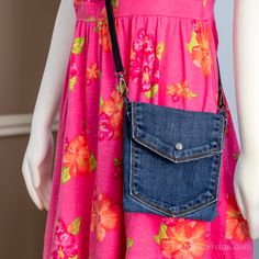 a woman's pink dress with floral print and blue denim pocket on the front