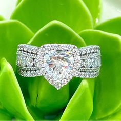 a diamond ring sitting on top of a green plant