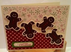 a christmas card with three gingerbreads on it