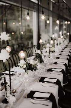 a long table with black and white place settings