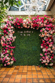 a floral display with pink flowers and greenery