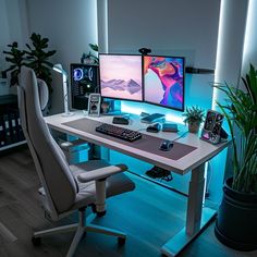 Modern home office setup with dual-monitor, ergonomic chair, and decorative plants, perfect for work and gaming. Stylish and functional desk space with ambient blue backlighting. Modern Gaming Setup, Organized Home Office, Office Decore, Dual Monitor Setup, Organized Home, Functional Desk