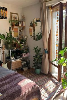 a bedroom with plants and pictures on the wall