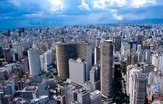 an aerial view of a city with tall buildings and skyscrapers in the foreground