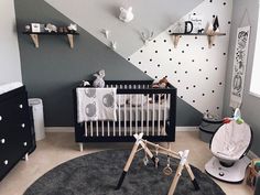 a baby's room with black and white decor