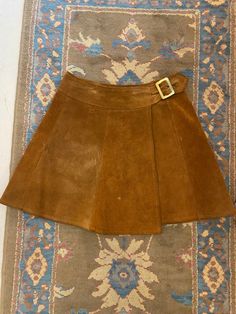 "1960's Brown Suede Leather Paneled Wrap Mini Skirt with Gold Brass Buckle  This skirt is so rock n roll! Woodstock, Almost Famous, Daisy Jones and the Six vibes 😍 Brand: Ardee California, USA  Fit: Small Waist: 26\" to 27.5\" Hip: up to 42\" Length: 17\" Condition: Good Vintage Condition. All sales are final. Thank you for shopping small + sustainable ❤️" Gold Aline Skirt, Vintage Brown Skirt For Party, Vintage Fall Party Skirt, Brown Mini Skirt Outfit, Suade Skirt, 1960s Mini Skirt, Vintage Mini Skirts, 60s Mini Skirt, Late 60s Fashion