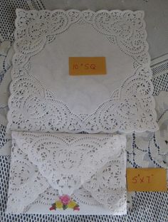 three white doily with yellow tags on them