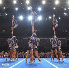 a group of cheerleaders standing on top of each other