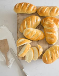 a cutting board topped with loaves of bread