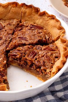 a pecan pie with one slice missing from it