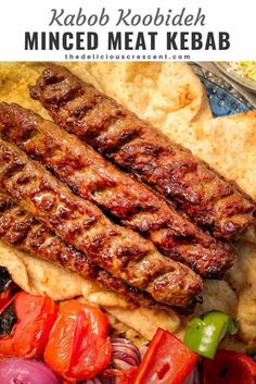 grilled meat with tomatoes, onions and peppers on a platter next to tortilla chips