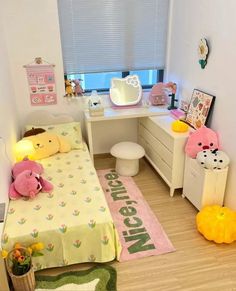 a small bedroom with teddy bears on the bed