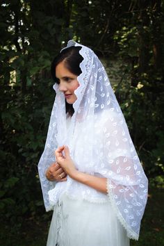 a woman wearing a white veil and dress