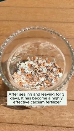 a glass bowl filled with food on top of a wooden table