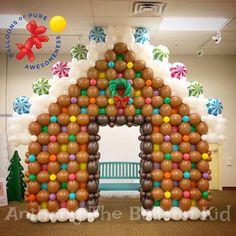 an inflatable gingerbread house decorated with balloons