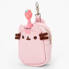 a pink purse with a cat on the front and a small keychain attached to it