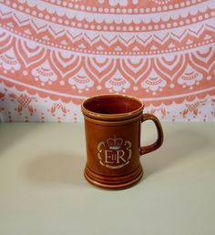 a brown coffee mug sitting on top of a table