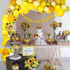 a birthday party with sunflowers and balloons