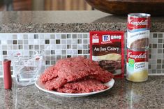 the ingredients for making hamburger patties are displayed on the counter top, including ground beef