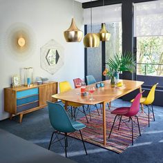 a dining room with colorful chairs and a wooden table