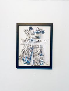 a white wall with a blue frame on it and a map hanging from the wall