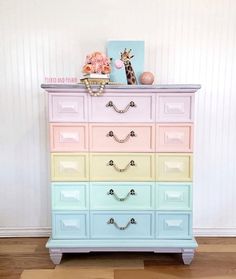 the dresser is painted in pastel colors