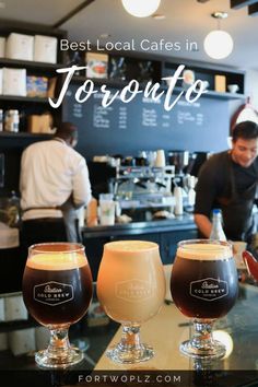 three glasses filled with different types of drinks on top of a counter in a restaurant