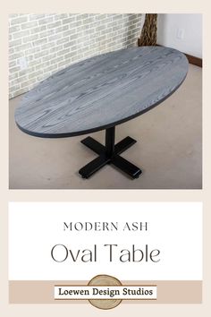 the modern ash oval table is shown with black metal legs and an oval wooden top