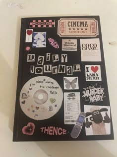 there is a dvd with various stickers on it and the words daily journal next to it