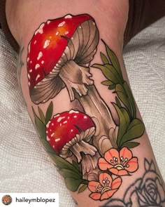 a mushroom tattoo on the leg with flowers