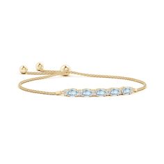 Oval icy-blue aquamarines, secured in an east-west setting, are accompanied with glittering diamonds in between them. This splendidly elegant 14k yellow gold bolo bracelet is adjustable to fit most wrists. Elegant Gold Aquamarine Bracelet, Elegant Light Blue Aquamarine Bracelet, Bracelet With Diamonds, Tanzanite Bracelet, Bolo Bracelet, Blue Topaz Bracelet, Aquamarine Bracelet, Chic And Elegant, Diamond Glitter