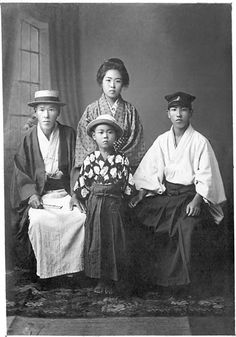 an old black and white photo shows three women in traditional japanese dress, one with a child on her lap