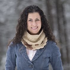 a woman wearing a scarf and jacket in the snow