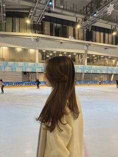 a woman standing on top of an ice rink