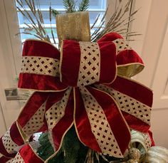 a christmas tree with red and gold ribbons