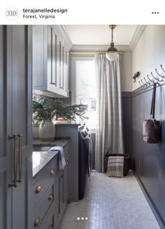 a narrow kitchen with gray cabinets and white tile flooring is featured in this magazine