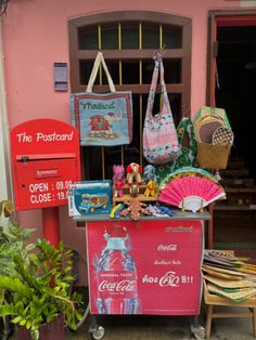 an old fashioned coca - cola machine with many items on display in front of it