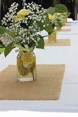 yellow roses and baby's breath in a mason jar on a white table cloth