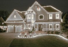 a large house covered in christmas lights at night