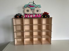 a toy truck sitting on top of a wooden shelf