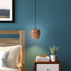 a bedroom with blue walls and a wooden headboard on a nightstand next to a bed