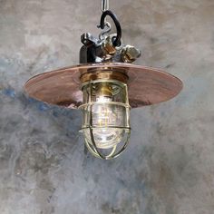 an old fashioned light fixture hanging from the ceiling