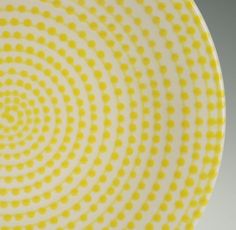 a yellow and white plate with circles on it