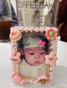 a baby in a photo frame with teddy bears on it's head and the words coffee bay