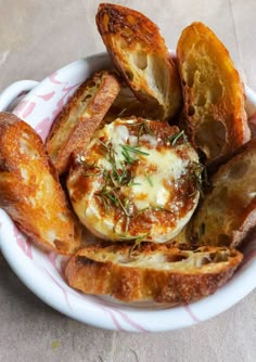 a white bowl filled with bread and cheese