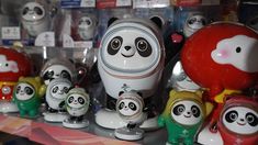 there are many panda figurines on the shelf