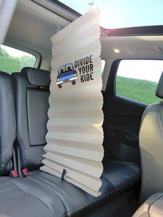 the back seat of a car with a sign on it that says divide your ride