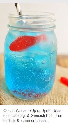 a jar filled with blue liquid and a red fish in it